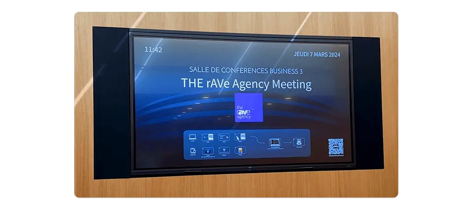 in-room display at a conference room featuring digital signage layered welcome content and messaging